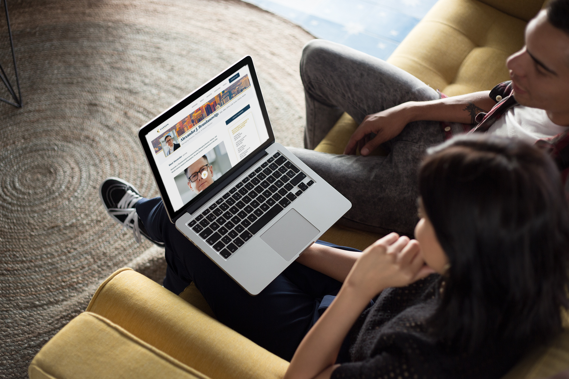 coworkers-working-on-a-macbook-mockup-while-talking-about-it