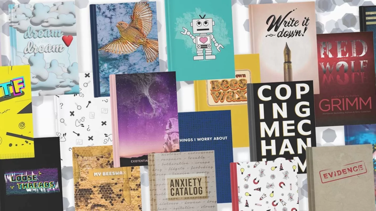 Collection of journal cover designs arranged in a haphazard overlapping way with confetti in the background